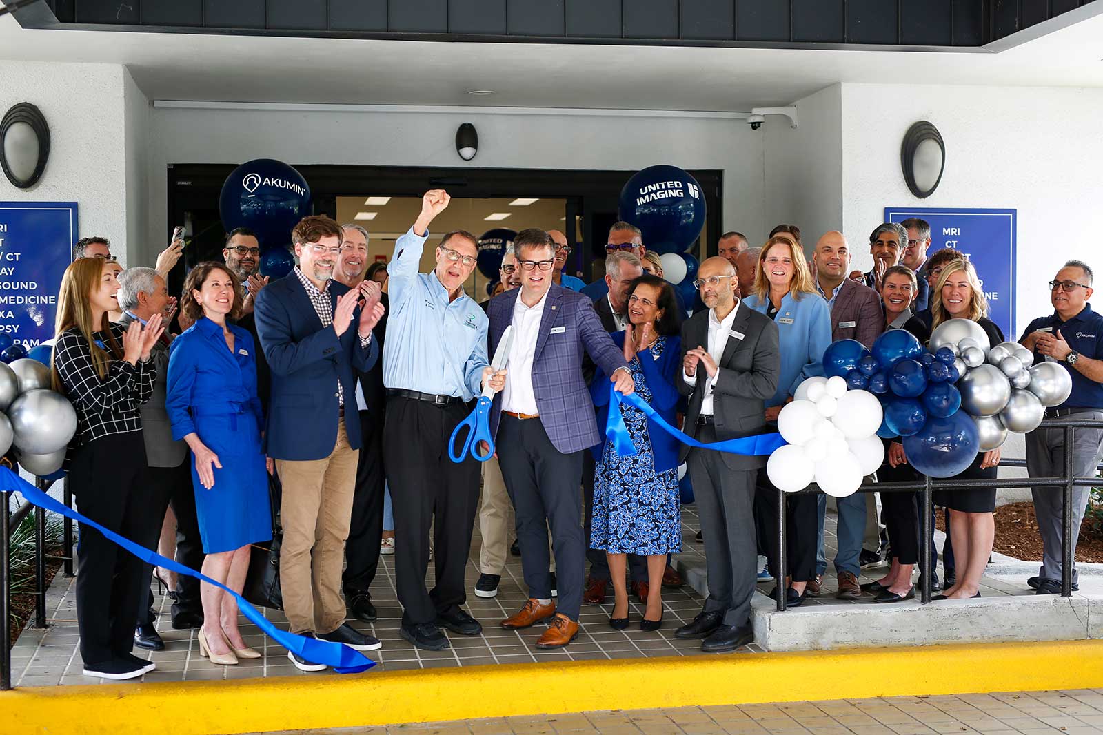Akumin and United Imaging team members cut a blue ribbon at the renovated Plantation imaging center open house